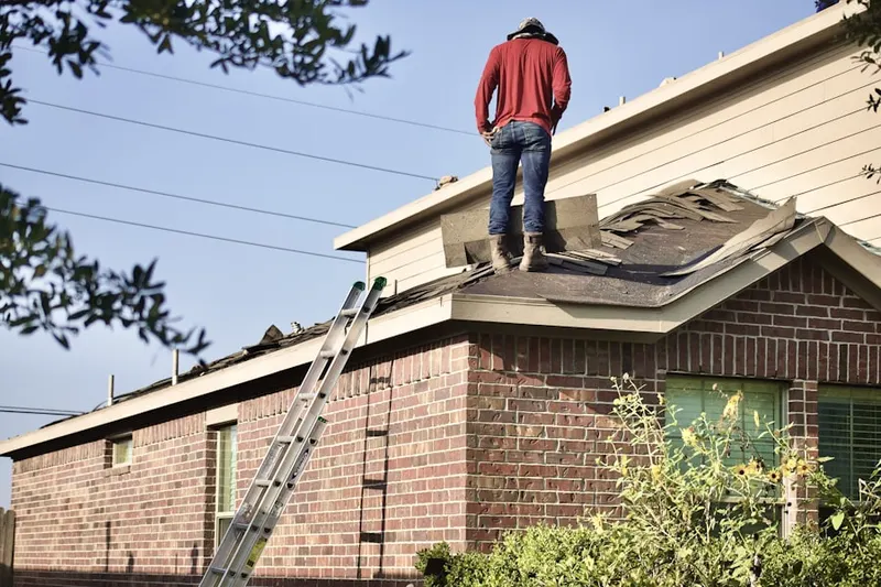 Professional roofer working on a residential roof in Brightwood